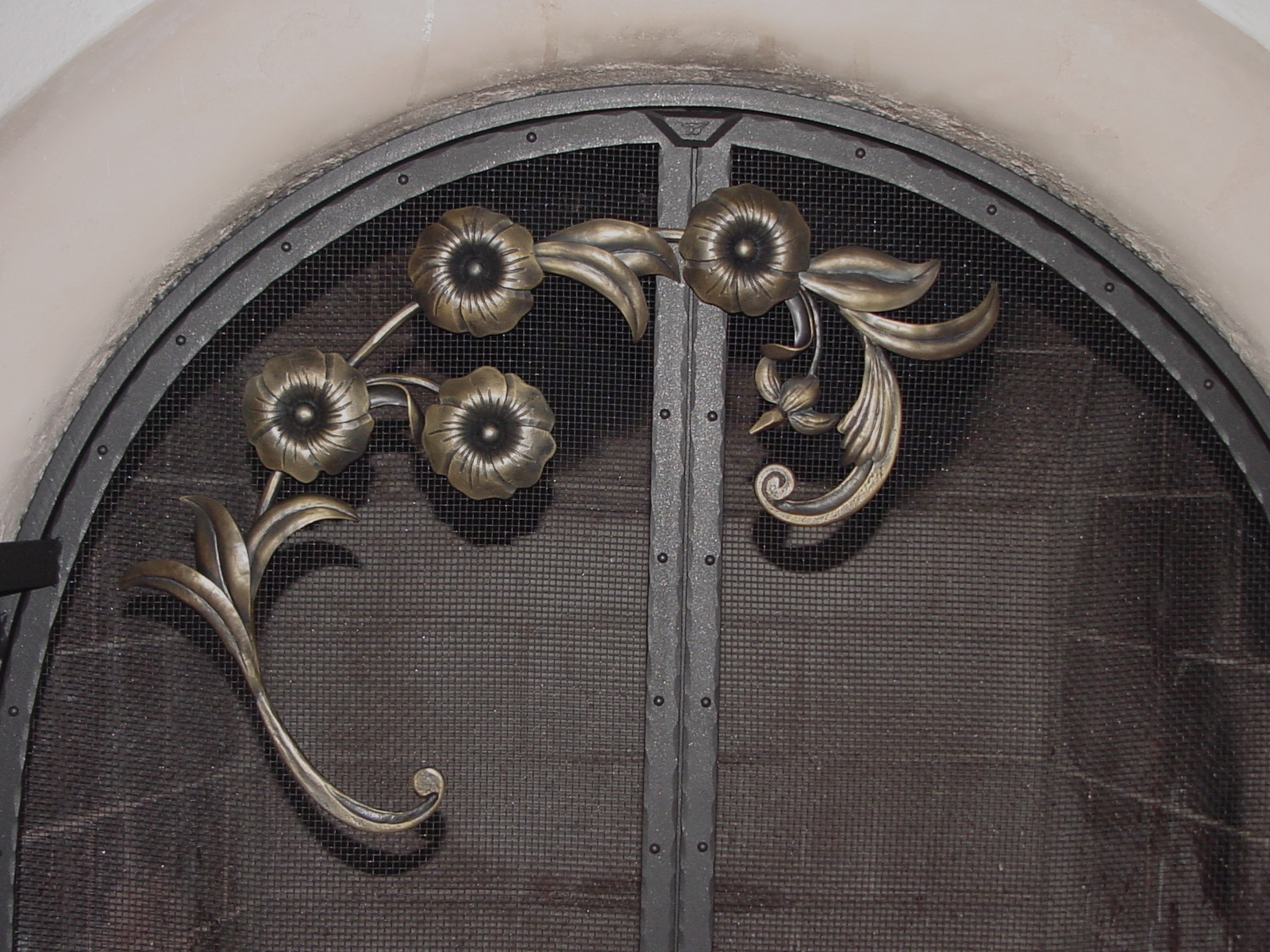 Forged floral detail on Kiva Screen Door unit