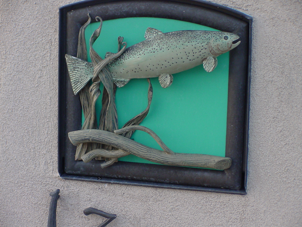 Detail of forged rainbow trout on mail box door