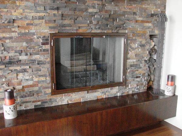 Contemporary lass Doors on a Stone Faced Fireplace